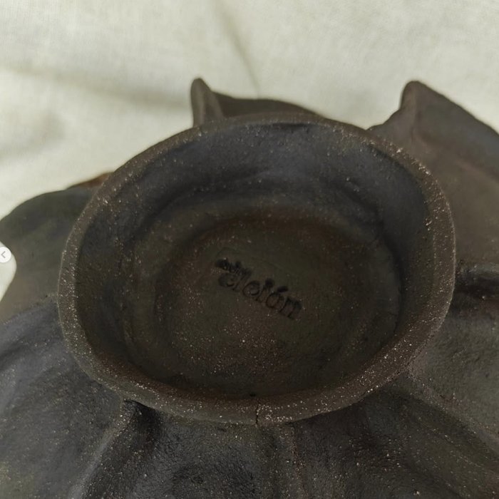 Underside of a ceramic piece stamped with the Cléion maker's mark
